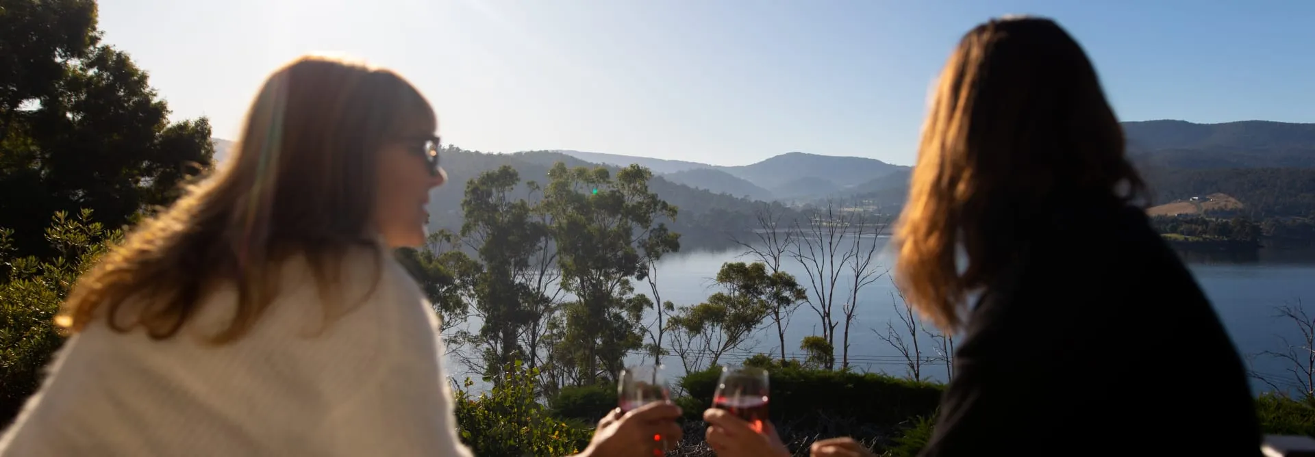 Two guests with wine overlooking the bay
